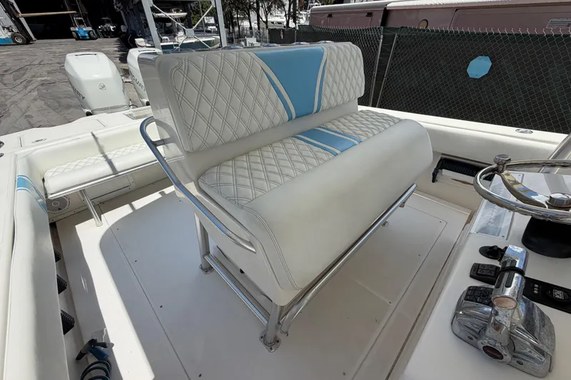 Slide: The Image of 2009 SeaVee 340B Cuddy boat interior with cushioned seating and steering wheel. - 26