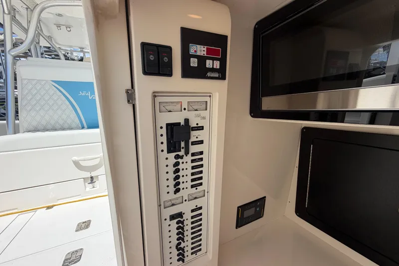 Slide: The Image of 2009 SeaVee 340B Cuddy interior with control panel and seating area. - 38