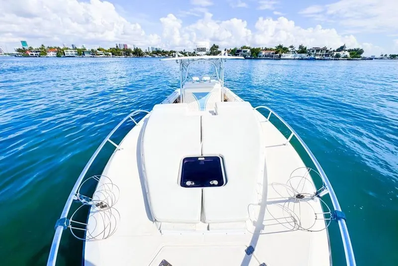 Slide: The Image of 2009 SeaVee 340B Cuddy boat on calm blue water, clear sky background. - 42