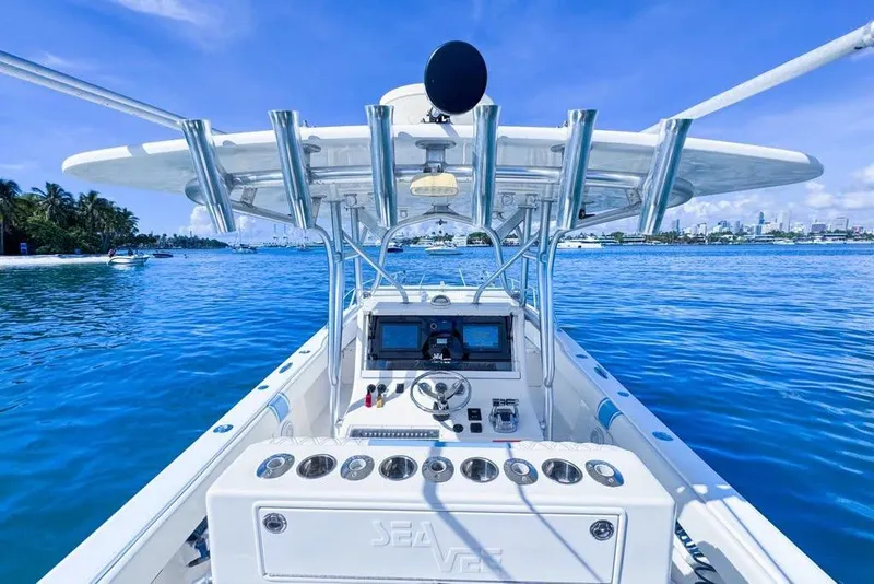 Slide: The Image of 2009 SeaVee 340B Cuddy boat on clear blue water, featuring a modern helm. - 43