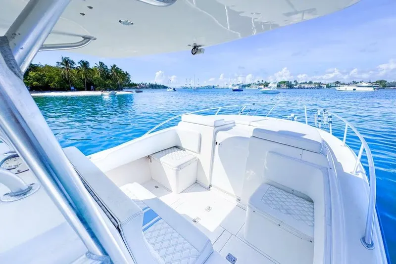 Slide: The Image of 2009 SeaVee 340B Cuddy boat on serene blue waters with lush shoreline. - 47