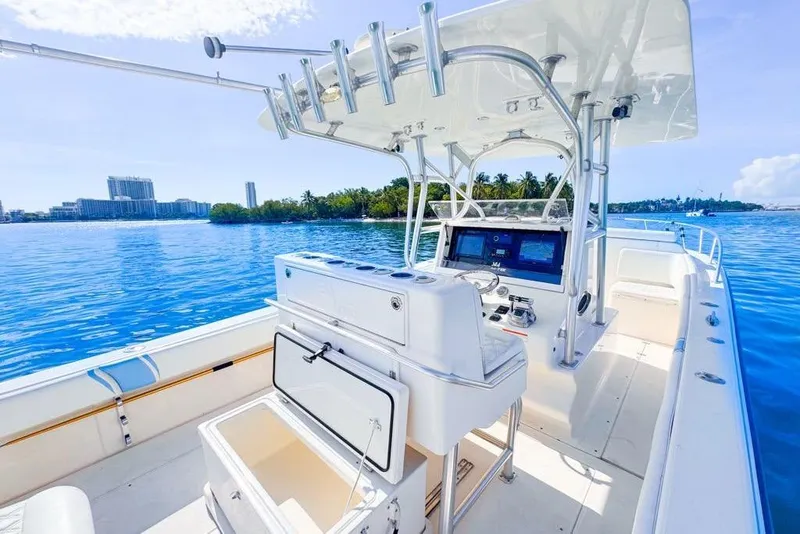 Slide: The Image of 2009 SeaVee 340B Cuddy boat on clear blue water, featuring a modern helm and open deck. - 48