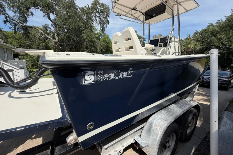 Slide: The Image of 1976 SeaCraft SC 23 Classic boat on trailer, featuring a sleek navy blue hull. - 10