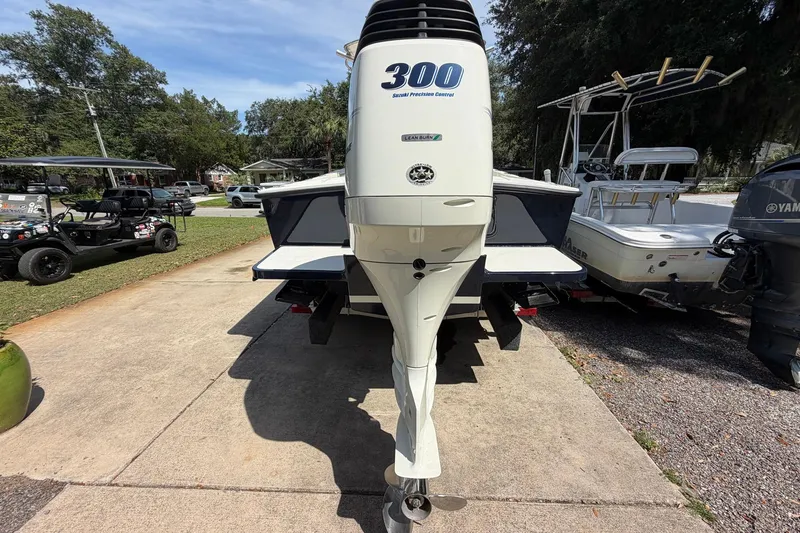 Slide: The Image of 1976 SeaCraft SC 23 Classic boat with powerful 300 horsepower outboard engine, parked outdoors. - 12