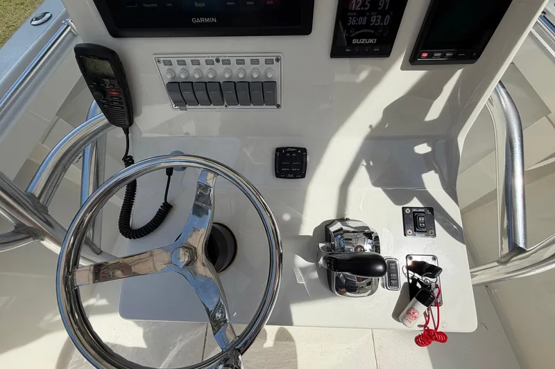 Slide: The Image of 1976 SeaCraft SC 23 Classic boat dashboard with steering wheel, controls, and navigation equipment. - 18