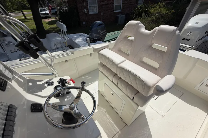 Slide: The Image of 1976 SeaCraft SC 23 Classic boat interior with steering wheel and cushioned seating. - 19