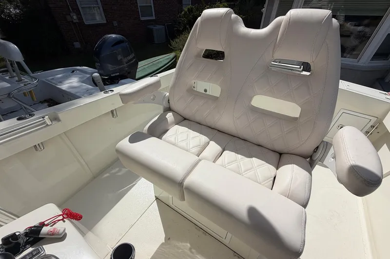 Slide: The Image of 1976 SeaCraft SC 23 Classic boat interior with white cushioned seating and Yamaha outboard motor. - 20