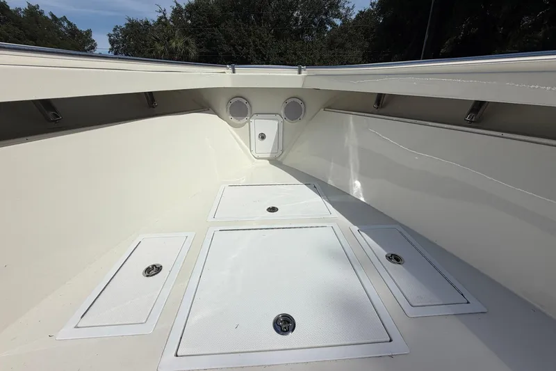 Slide: The Image of 1976 SeaCraft SC 23 Classic boat interior with storage compartments and clean white finish. - 22