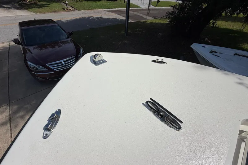 Slide: The Image of 1976 SeaCraft SC 23 Classic boat deck with cleats, parked car nearby. - 23