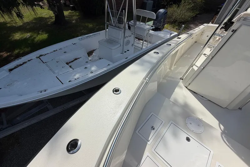 Slide: The Image of 1976 SeaCraft SC 23 Classic boat, showcasing deck and seating area in sunlight. - 24
