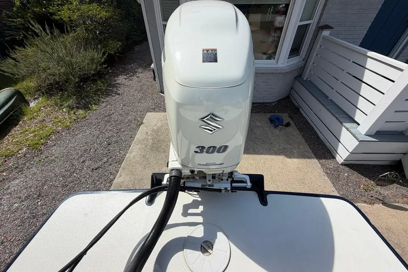 Slide: The Image of 1976 SeaCraft SC 23 Classic with Suzuki 300 outboard motor, parked on concrete. - 25