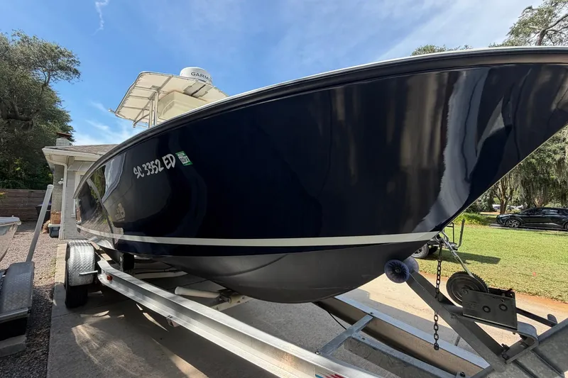 Slide: The Image of 1976 SeaCraft SC 23 Classic boat on trailer, parked outdoors under clear sky. - 3