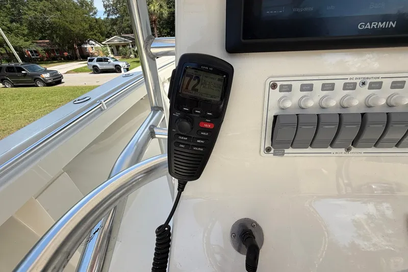 Slide: The Image of 1976 SeaCraft SC 23 Classic boat dashboard with Garmin display and radio controls. - 31