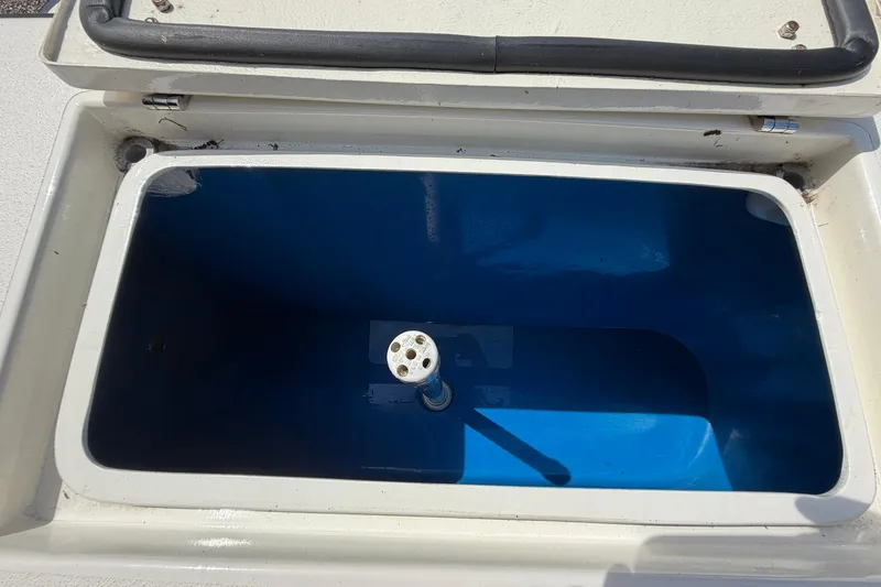 Slide: The Image of Open storage compartment on 1976 SeaCraft SC 23 Classic boat, featuring a blue interior. - 41