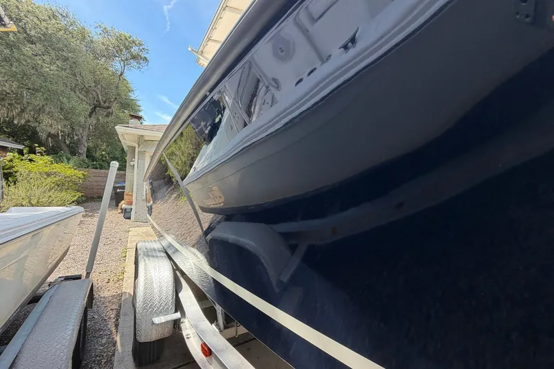 Slide: The Image of 1976 SeaCraft SC 23 Classic boat on trailer, parked outdoors under clear sky. - 5