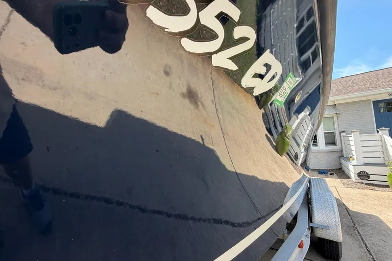 Slide: The Image of 1976 SeaCraft SC 23 Classic boat on trailer, reflecting surroundings. - 6
