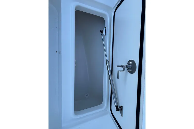 Slide: The Image of Open storage compartment on 2026 Mako 226 Center Console boat. - 10