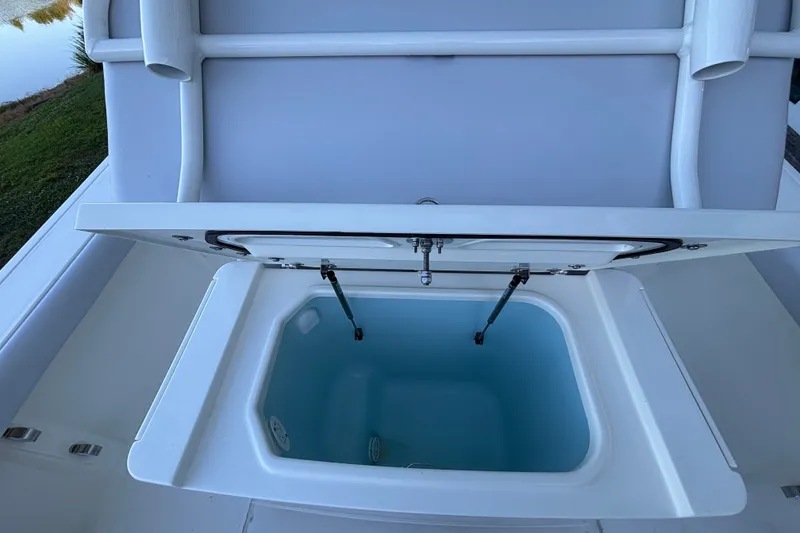Slide: The Image of Open storage compartment on 2026 Mako 226 Center Console boat. - 5