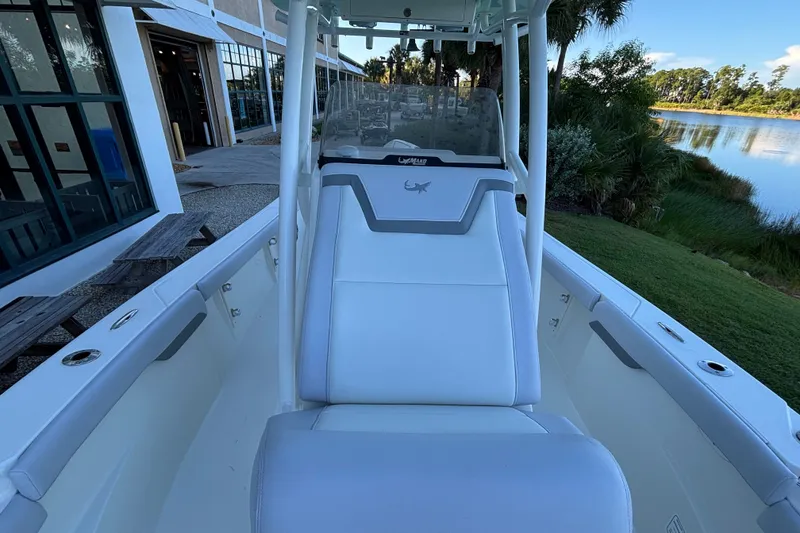 Slide: The Image of 2026 Mako 226 Center Console boat with sleek seating and scenic waterfront view. - 8
