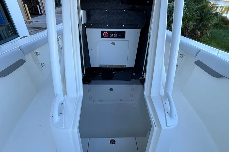 Slide: The Image of 2026 Mako 226 Center Console interior with storage compartment and control panel. - 9