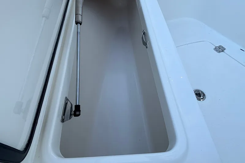 Slide: The Image of Open storage compartment on 2026 Mako 226 Center Console boat. - 11