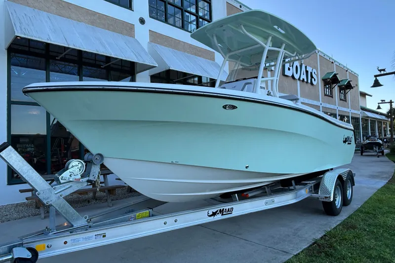 Slide: The Image of 2026 Mako 226 Center Console boat on trailer outside a dealership. - 1