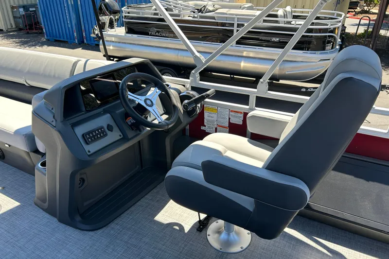Slide: The Image of 2026 Sun Tracker Sportfish 24 XP3 boat interior with steering console and captain's chair. - 31