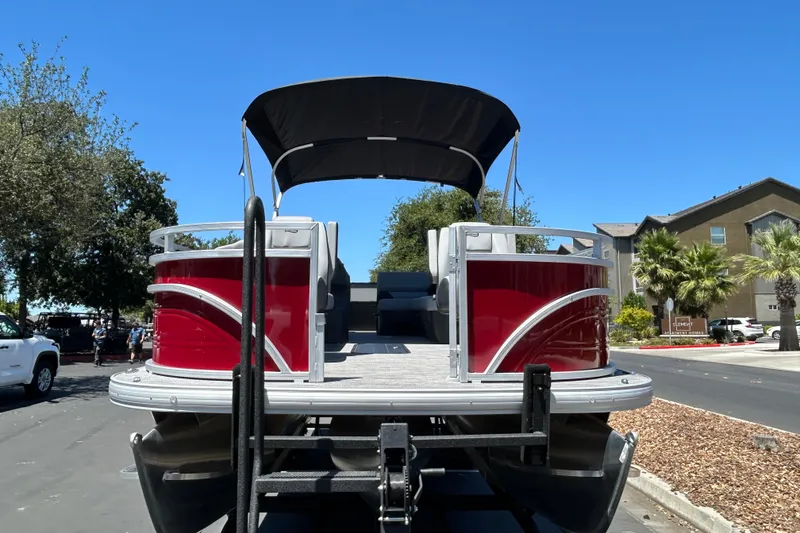 Slide: The Image of 2026 Sun Tracker Sportfish 24 XP3 pontoon boat with red exterior and black canopy. - 7