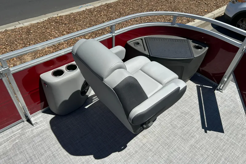 Slide: The Image of 2026 Sun Tracker Sportfish 24 XP3 boat interior with gray seating and cup holders. - 37