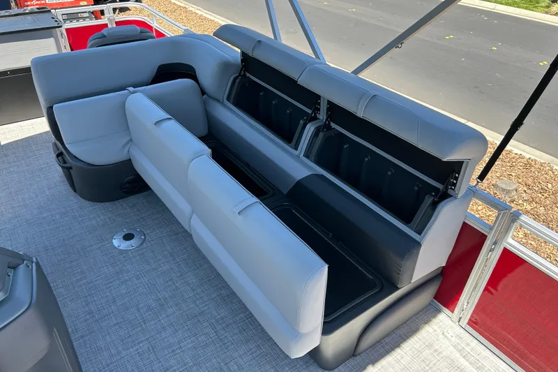 Slide: The Image of 2026 Sun Tracker Sportfish 24 XP3 boat interior with gray seating and storage compartments. - 15