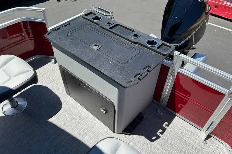 Slide: The Image of 2026 Sun Tracker Sportfish 24 XP3 boat interior with seating and storage unit. - 25