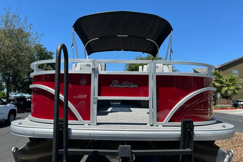 Slide: The Image of 2026 Sun Tracker Sportfish 24 XP3 pontoon boat with red exterior and canopy. - 8