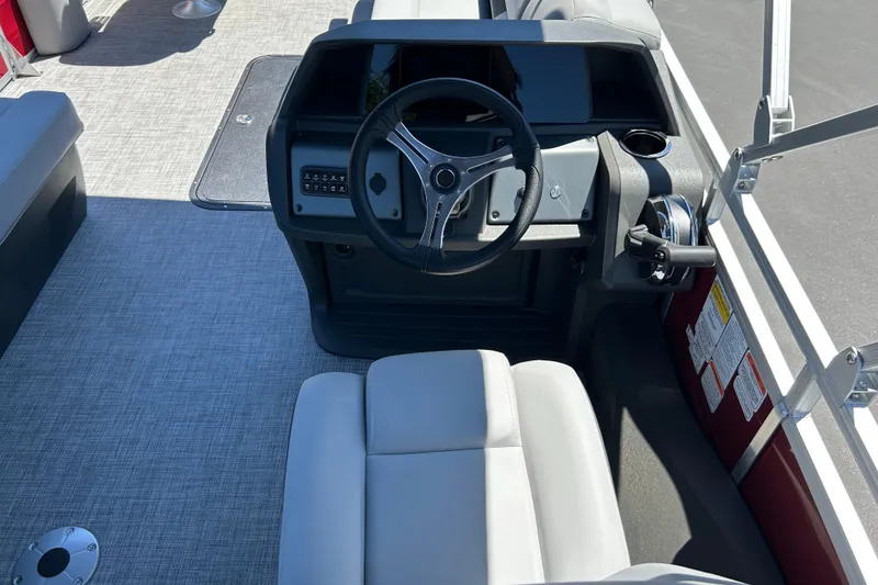 Slide: The Image of Interior view of 2026 Sun Tracker Sportfish 24 XP3 boat cockpit with steering wheel. - 29