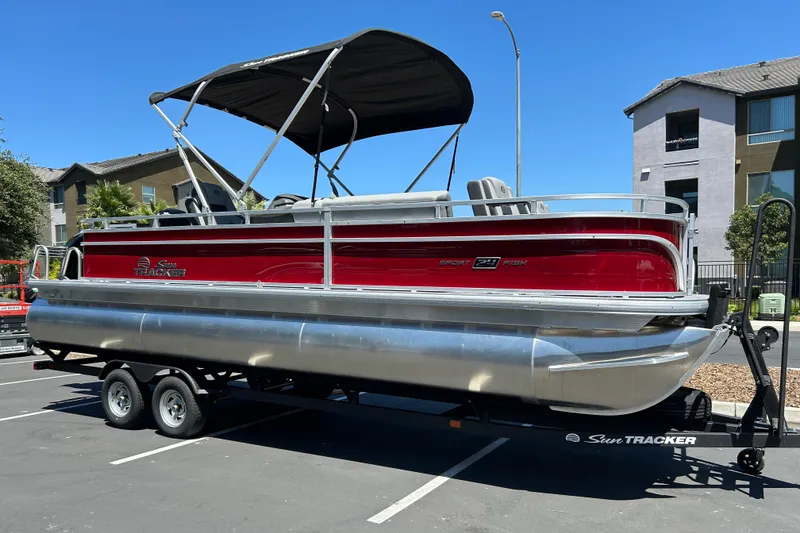 Slide: The Image of 2026 Sun Tracker Sportfish 24 XP3 pontoon boat on trailer in parking lot. - 6