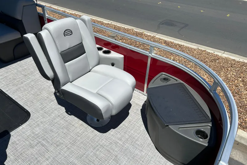 Slide: The Image of 2026 Sun Tracker Sportfish 24 XP3 boat seat and console, featuring sleek design and cup holders. - 10