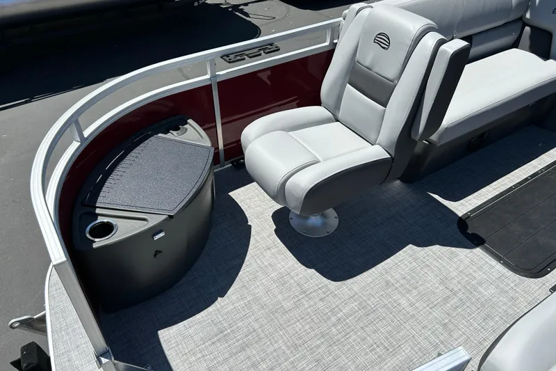 Slide: The Image of 2026 Sun Tracker Sportfish 24 XP3 boat interior with seating and storage compartment. - 9