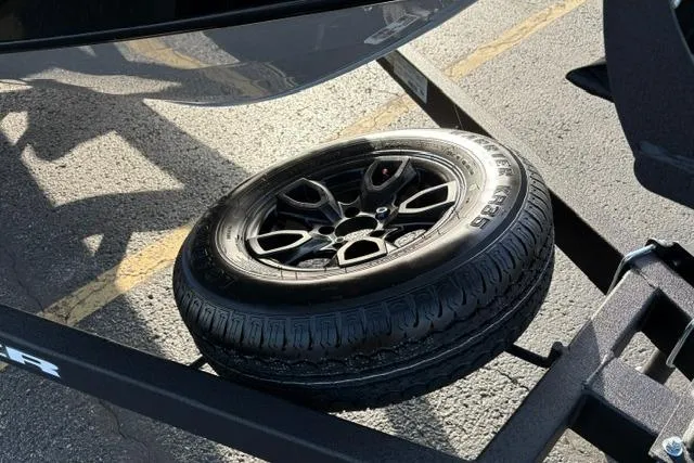 Slide: The Image of Spare tire mounted on a 2026 Tracker Pro Guide V-175 WT trailer. - 19