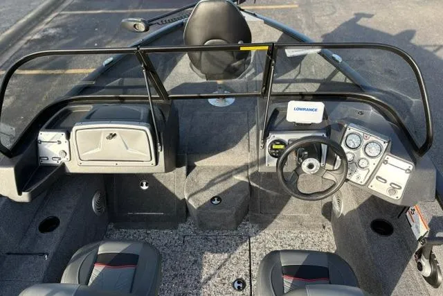 Slide: The Image of Interior view of 2026 Tracker Pro Guide V-175 WT boat with steering wheel and dashboard controls. - 12