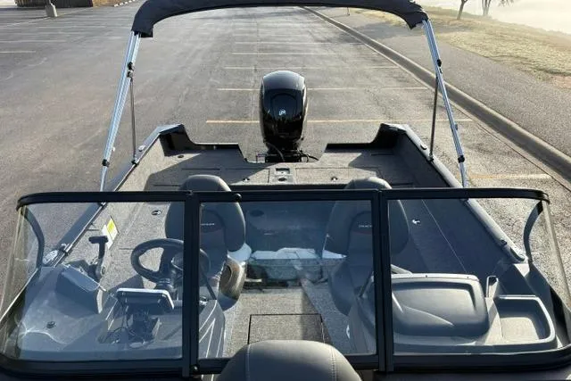 Slide: The Image of 2026 Tracker Pro Guide V-175 WT boat with canopy and dual seating in a parking lot. - 11