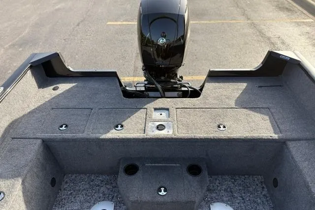 Slide: The Image of 2026 Tracker Pro Guide V-175 WT boat interior with motor, featuring spacious storage compartments. - 23