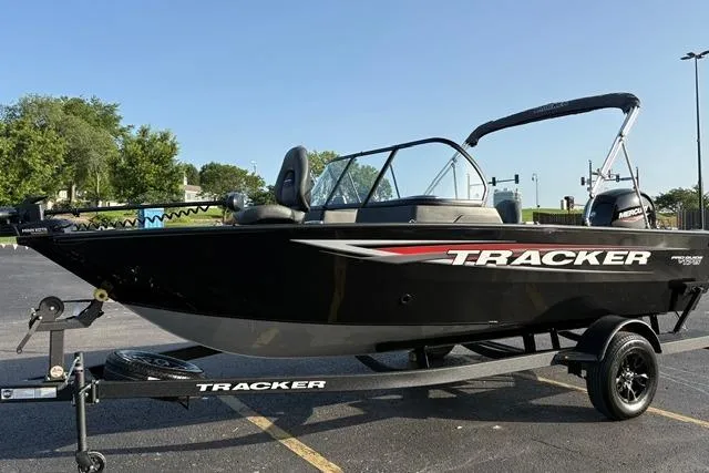 Slide: The Image of 2026 Tracker Pro Guide V-175 WT boat on trailer in parking lot. - 2