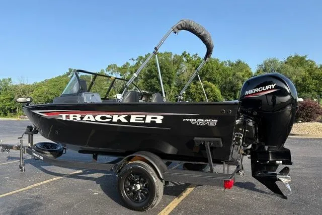 Slide: The Image of 2026 Tracker Pro Guide V-175 WT boat with Mercury engine, parked outdoors. - 8