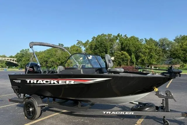 Slide: The Image of 2026 Tracker Pro Guide V-175 WT boat on trailer, parked outdoors. - 14