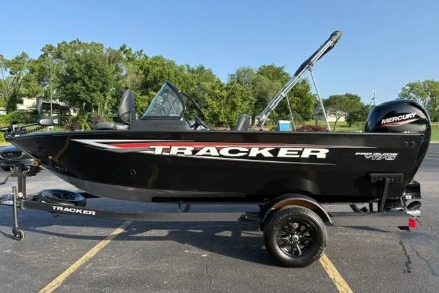 Slide: The Image of 2026 Tracker Pro Guide V-175 WT boat on trailer, black exterior, parked outdoors. - 4