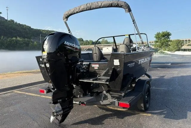 Slide: The Image of 2026 Tracker Pro Guide V-175 WT boat with Mercury outboard motor in a scenic setting. - 7