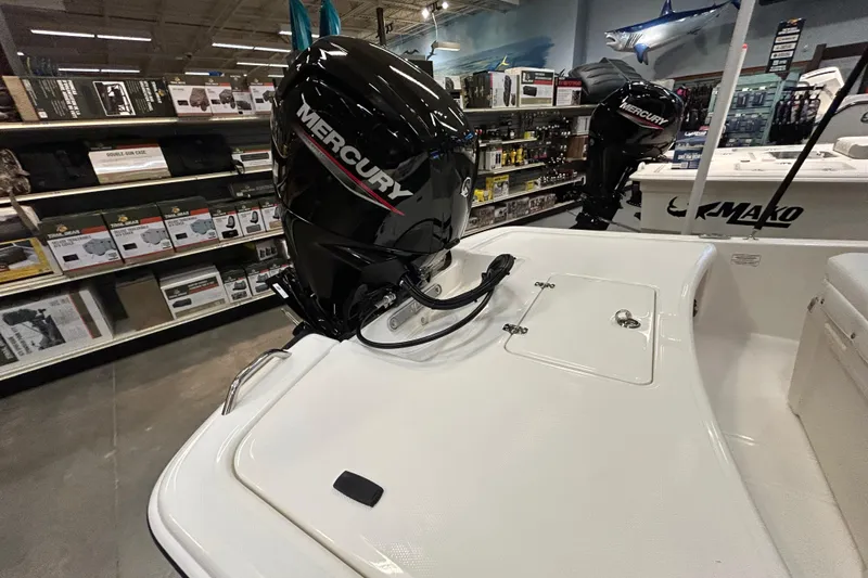 Slide: The Image of 2026 Mako Pro Skiff 17 CC with Mercury outboard motor in a showroom. - 5