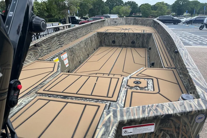 Slide: The Image of 2026 Tracker Grizzly 1650 T Prairie Wings Edition boat with camo design and spacious deck. - 9