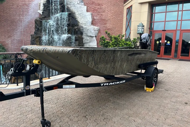 The Image of 2026 Tracker Grizzly 1650 T Prairie Wings Edition boat on trailer, near waterfall. - 0