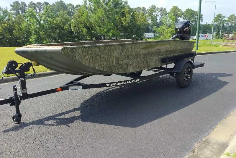 Slide: The Image of 2026 Tracker Grizzly 1650 T Prairie Wings Edition boat on trailer, parked on road. - 7