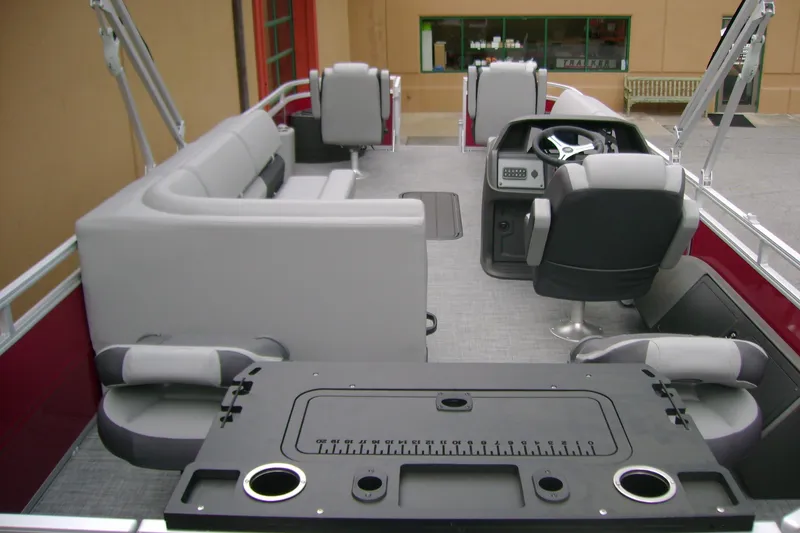 Slide: The Image of 2026 Sun Tracker Sportfish 24 XP3 pontoon boat interior with seating and helm. - 11